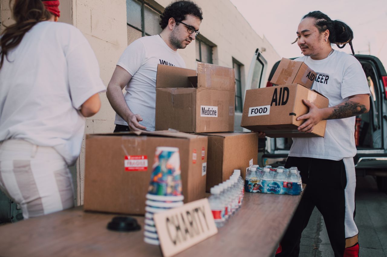 Crafting Captivating Headlines: Your awesome post title goes here Volunteers loading aid boxes with food and medicine from a van outdoors.